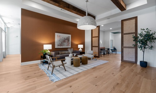 Open-concept clubhouse at Evermore Apartments featuring lounge seating, wood accents, and co-working space