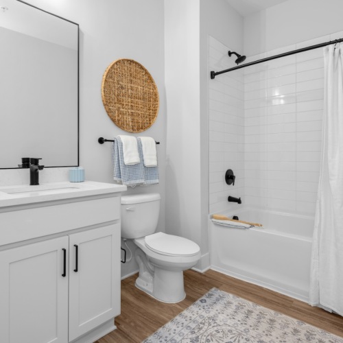 a spacious bathroom with a large mirror and ample light