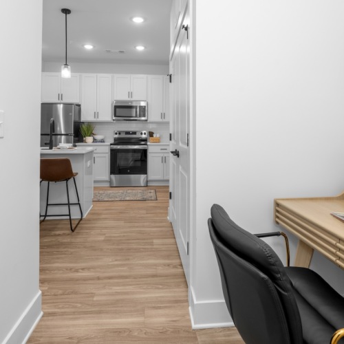 a study nook leading into a kitchen