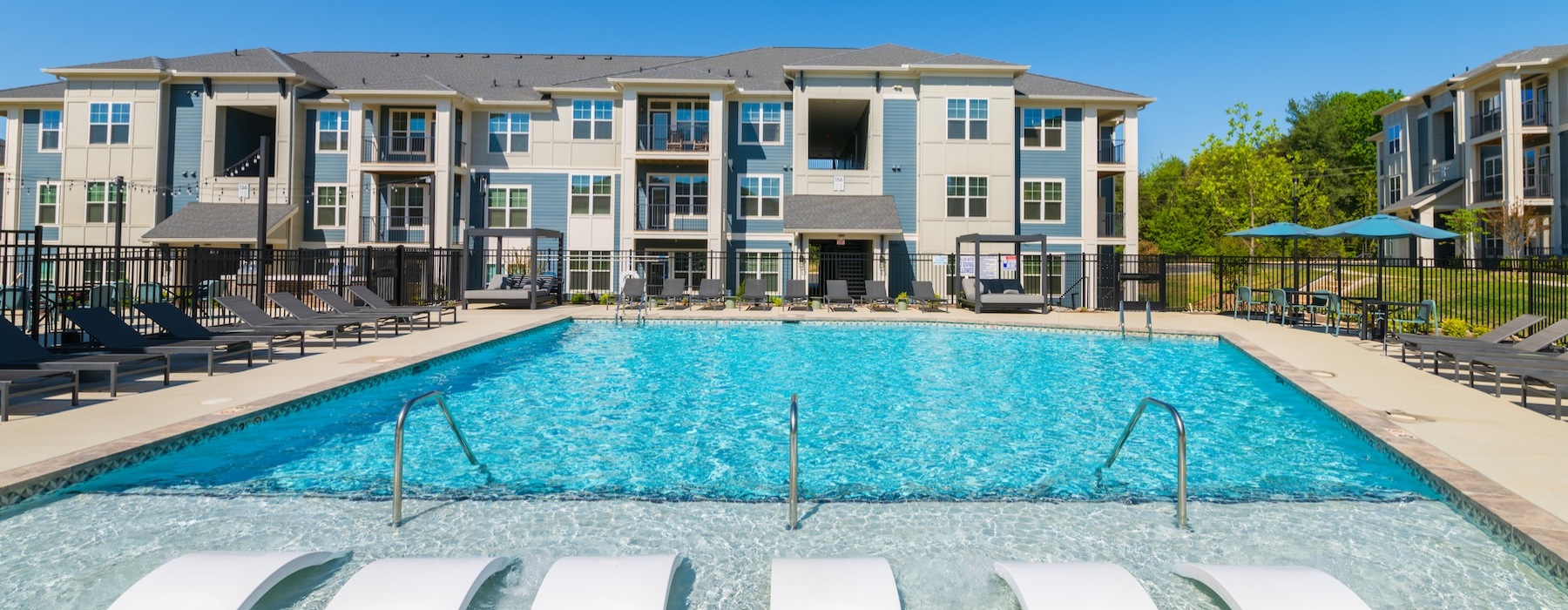 a swimming pool with lounge chairs
